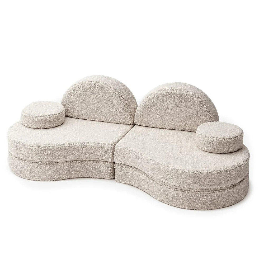 1. Modular kids' sofa in Bearly light gray with rounded shapes and two round cushions, shown in a playful arrangement