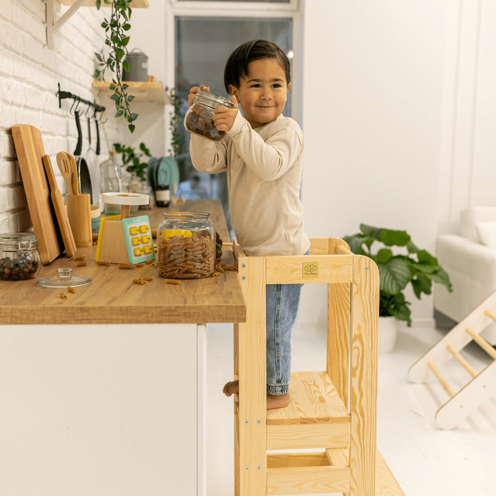 7. Child using MeowBaby kitchen helper, reaching for items on a kitchen counter