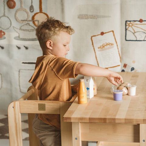 3. Child using MeowBaby kitchen helper at table, engaging in play with toy food items