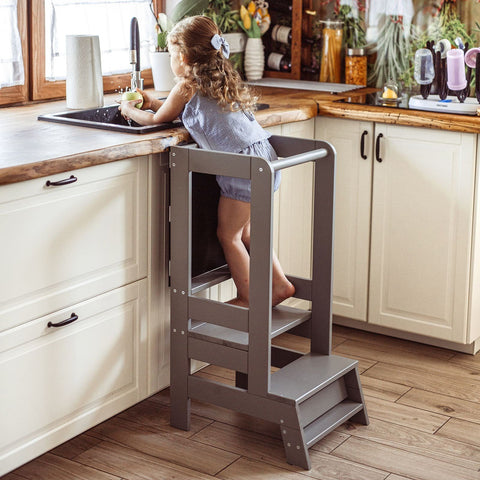 1. Girl using dark grey MeowBaby kitchen helper at sink in bright kitchen