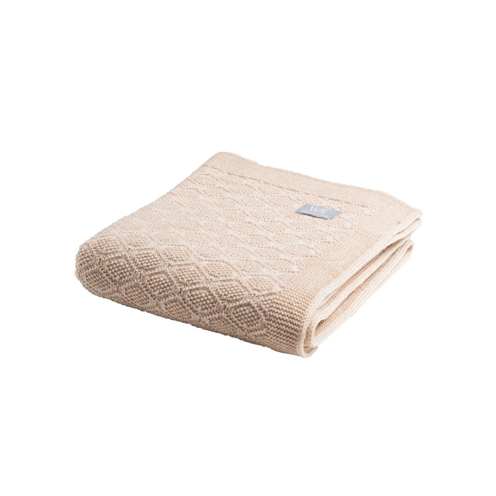 17. Folded light beige merino wool baby blanket with brand tag on white background
