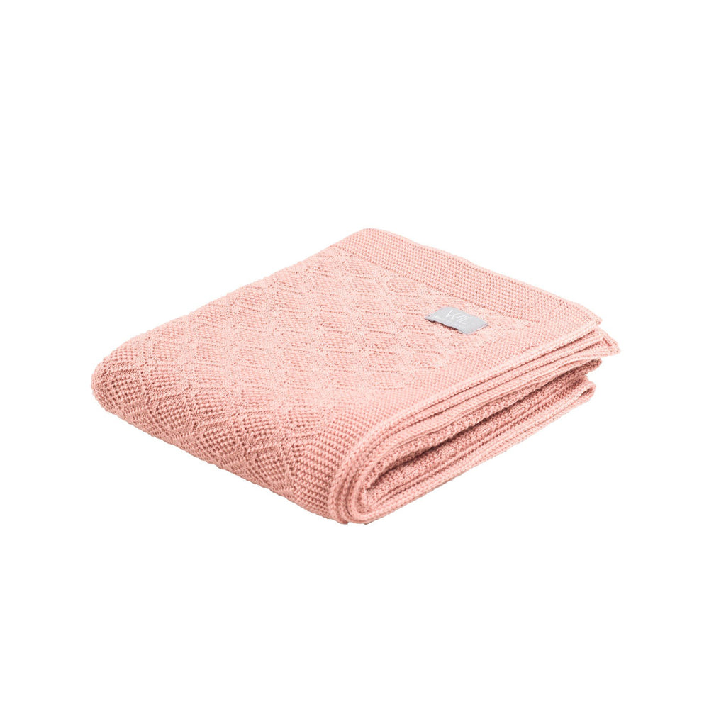 15. Folded pink merino wool baby blanket with brand tag on white background