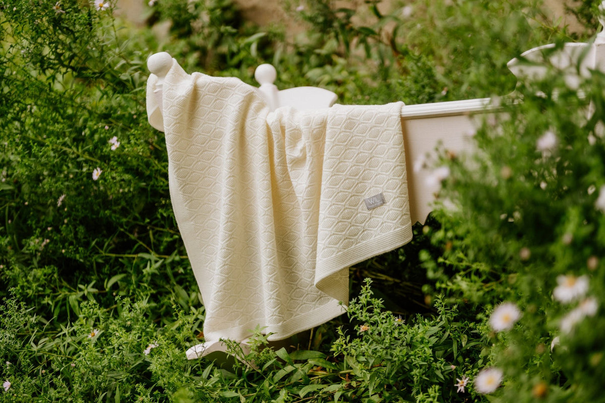 5. Cream merino wool blanket hanging on line surrounded by greenery