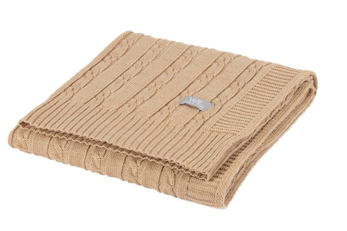 5. Folded tan merino wool baby blanket with cable knit design and Wool In Love logo on white background