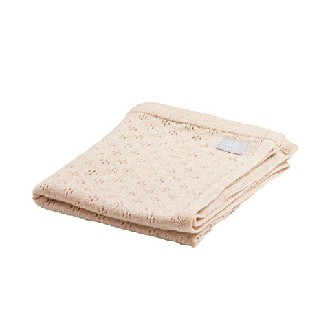 4. Folded beige merino wool baby blanket with floral pattern on white background