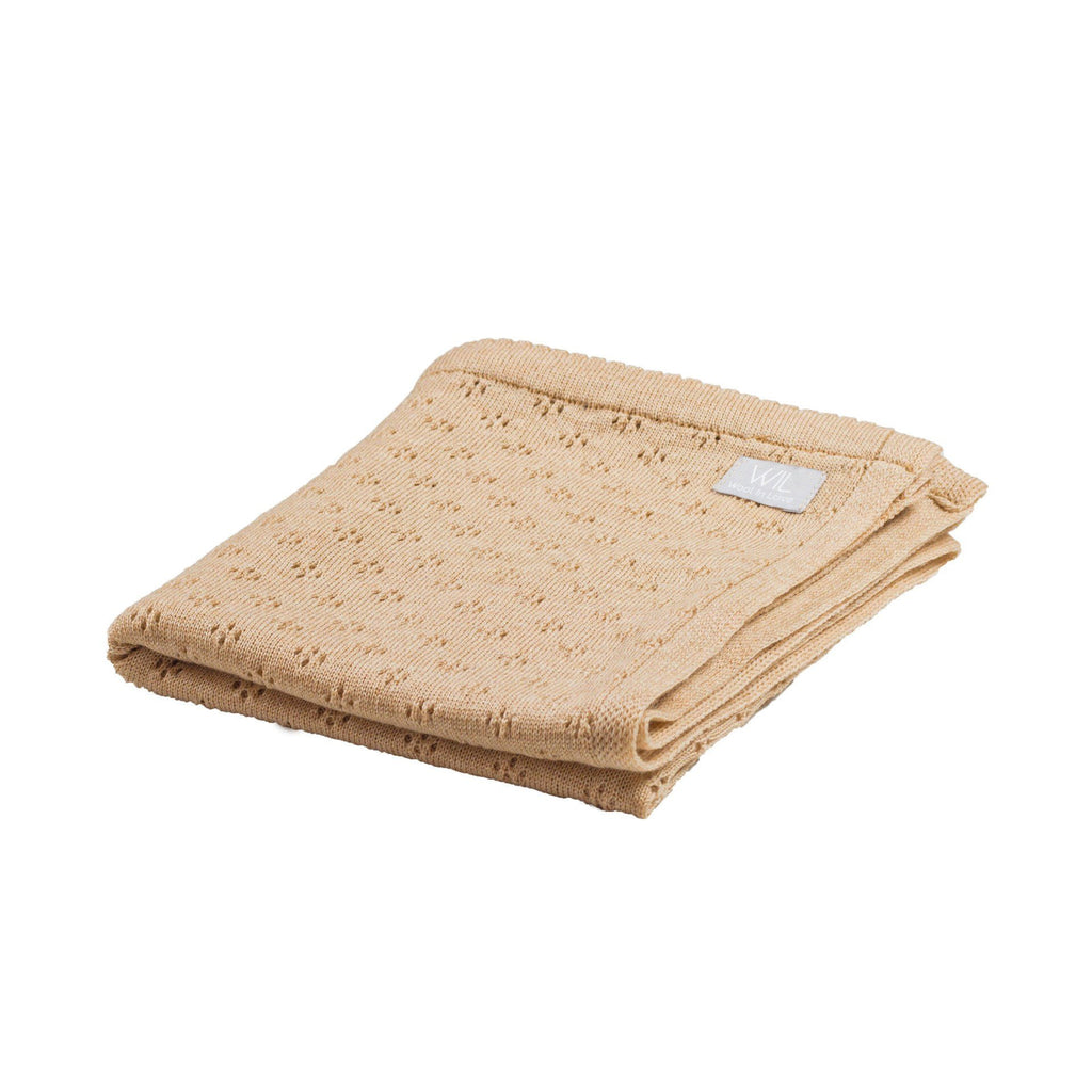 5. Folded tan merino wool baby blanket with floral pattern on white background