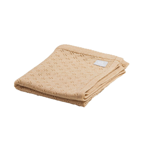 5. Folded tan merino wool baby blanket with floral pattern on white background