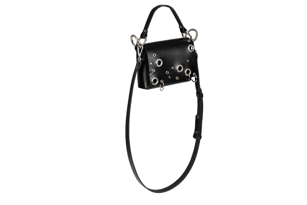 6. Side view of PYKOK Handbag Mia in black leather, showing studded design and strap