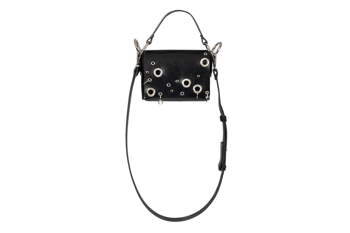 5. Studio shot of PYKOK Handbag Mia in black leather with metal details and adjustable strap