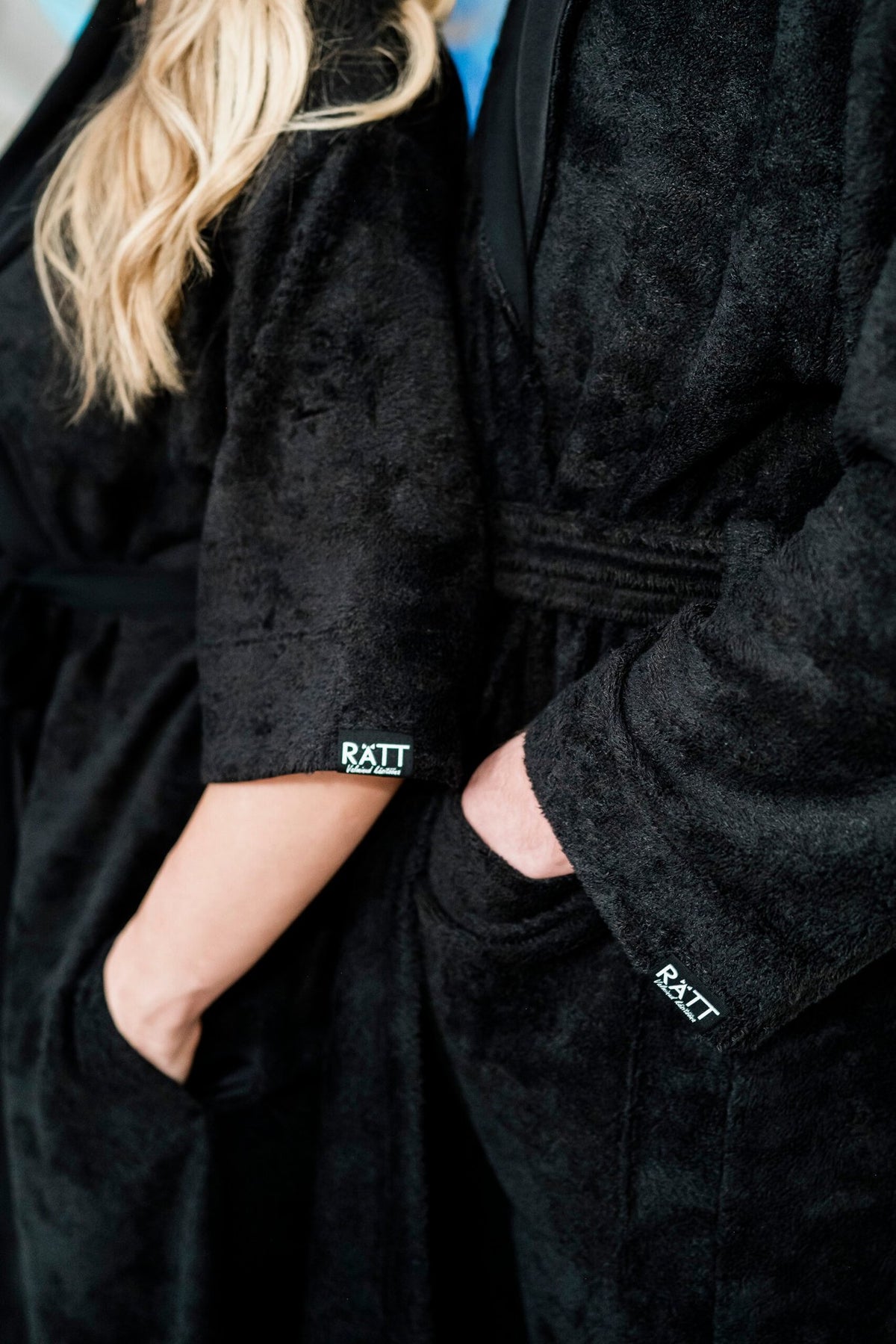 3. Close-up of RÄTT logo on sleeve of black bamboo terry robe with side pocket detail