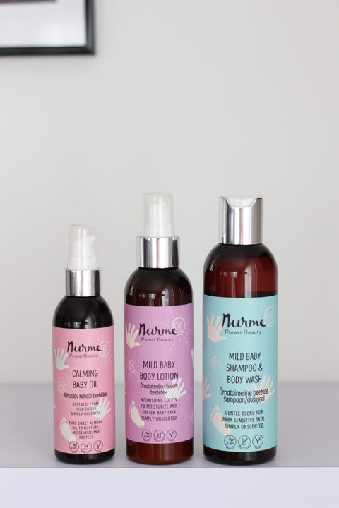 1. Trio of Nurme baby products including Mild Baby Body Lotion, Calming Baby Oil, and Shampoo & Body Wash on a shelf