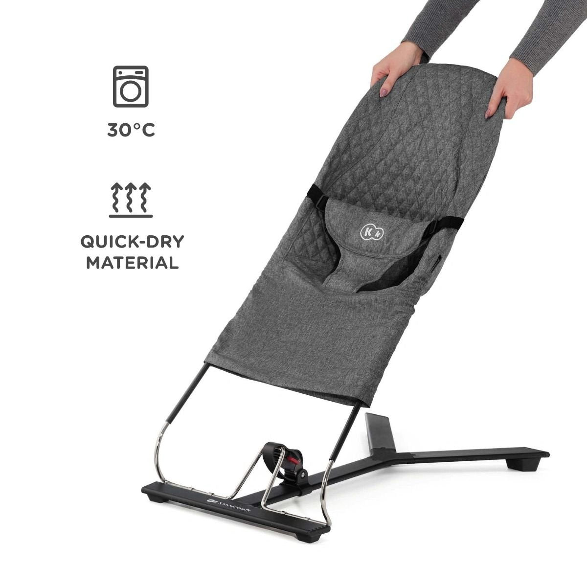2. Grey Kinderkraft MIMI bouncer with quick-dry material, shown with hands adjusting in studio setting
