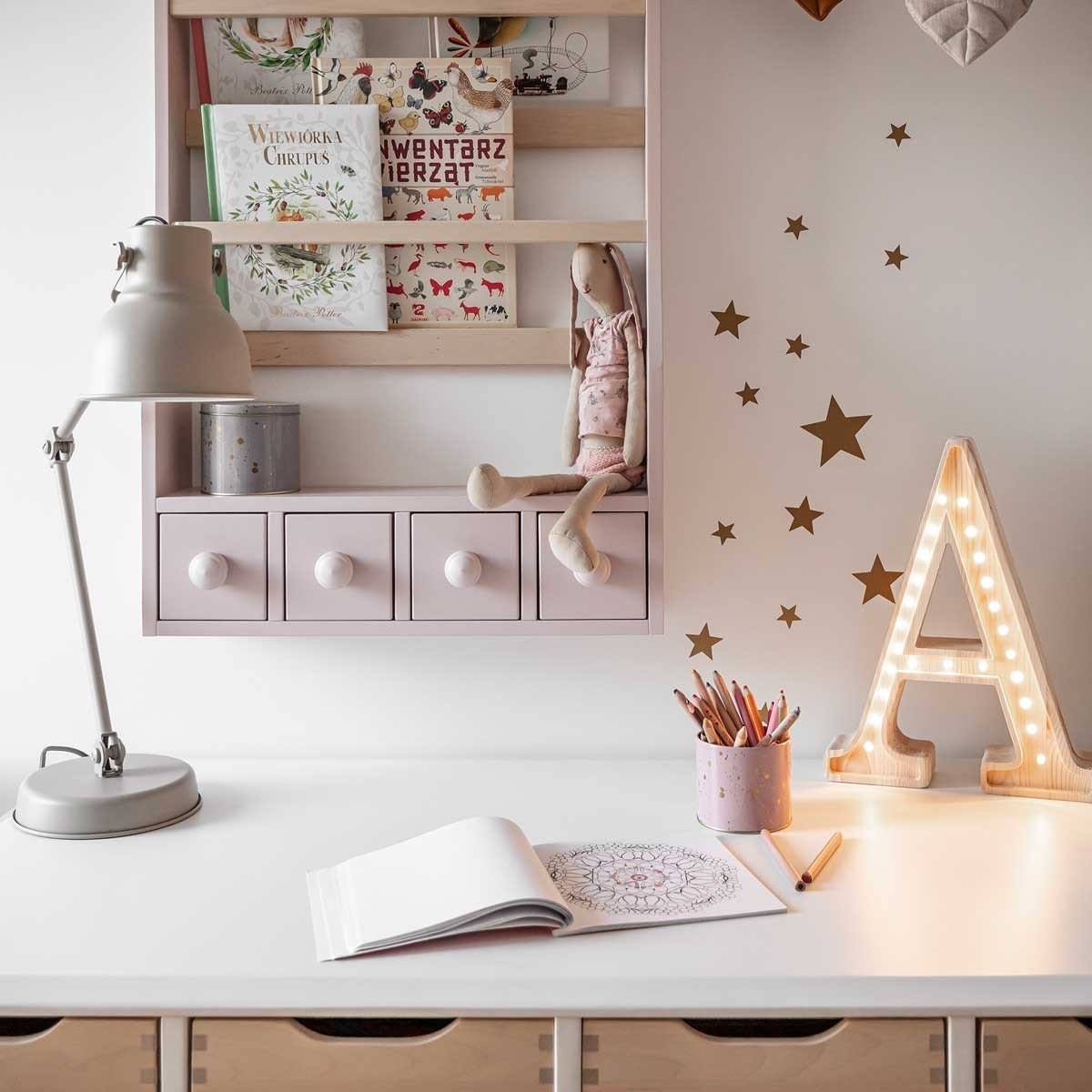3. Kids' study area with gold star wall stickers, pink shelf, and illuminated letter A