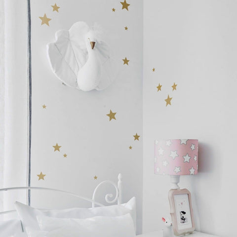 1. Children's room with gold star wall stickers, white bed, pink star lamp, and swan wall decor