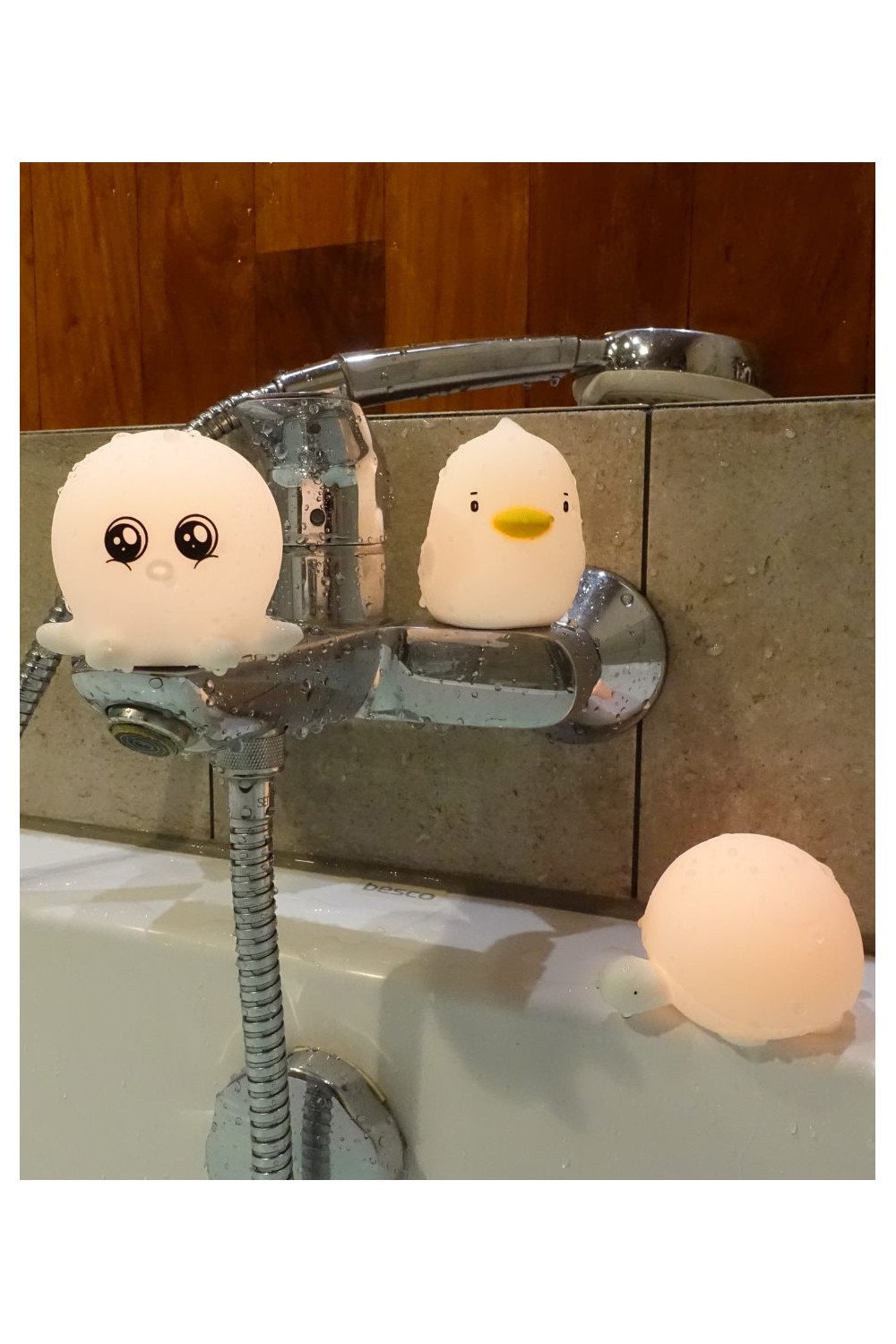 2. Duck and octopus shaped silicone lamps on bathtub faucet with turtle lamp on edge