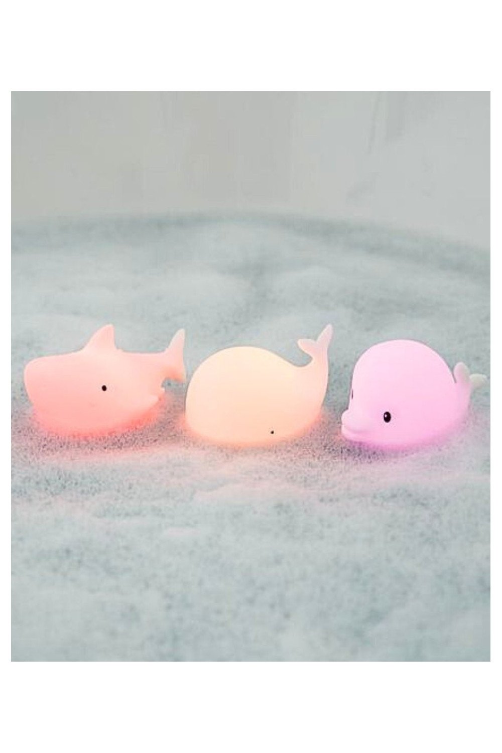 6. Three glowing marine silicone lamps, Dolphin, Whale, and Shark, floating on water surface