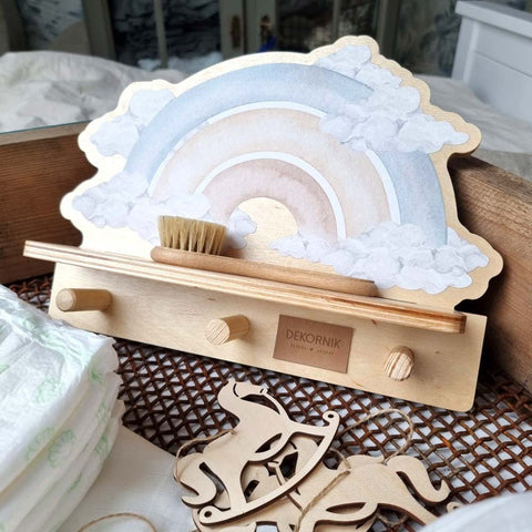 4. Close-up of mini wall shelf with blue rainbow design, featuring a brush and wooden horse decor