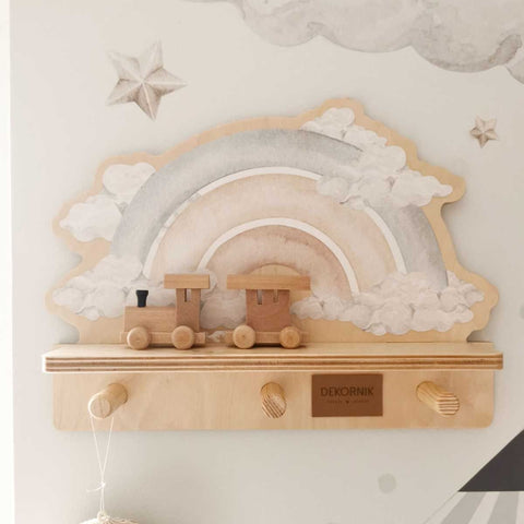 1. Mini wall shelf with blue rainbow design and wooden train decor, mounted on a wall with star and cloud decals