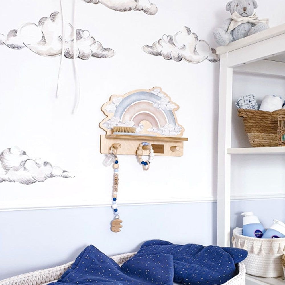 8. Mini wall shelf with blue rainbow design in a nursery, surrounded by cloud decals and a teddy bear
