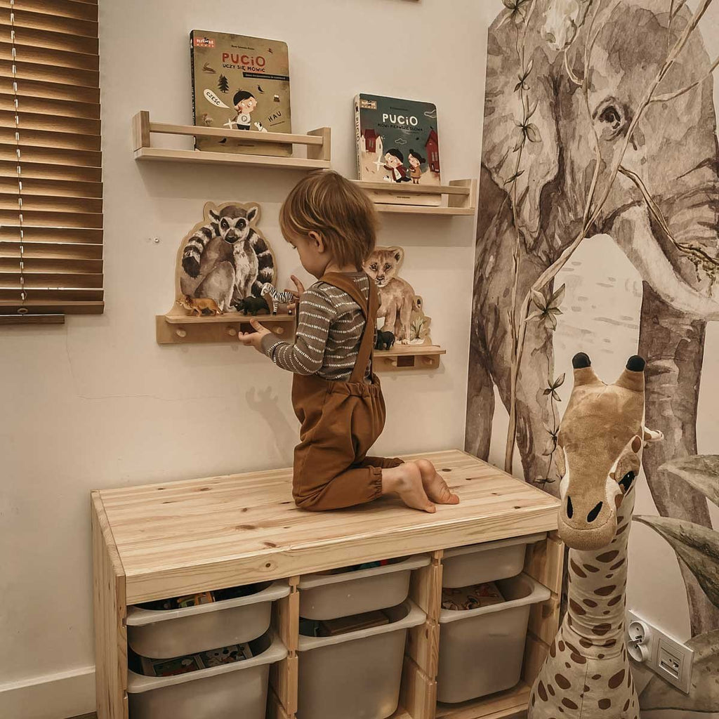 1. Child playing with Dekornik mini wall shelf with lemur design in a cozy room setting