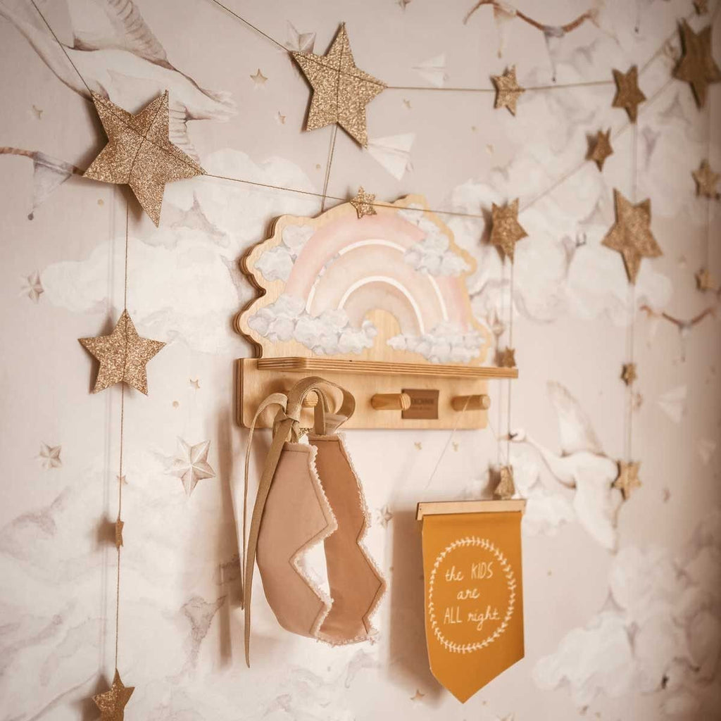 1. Dekornik pink rainbow mini wall shelf in a child's room with star garland and hanging accessories