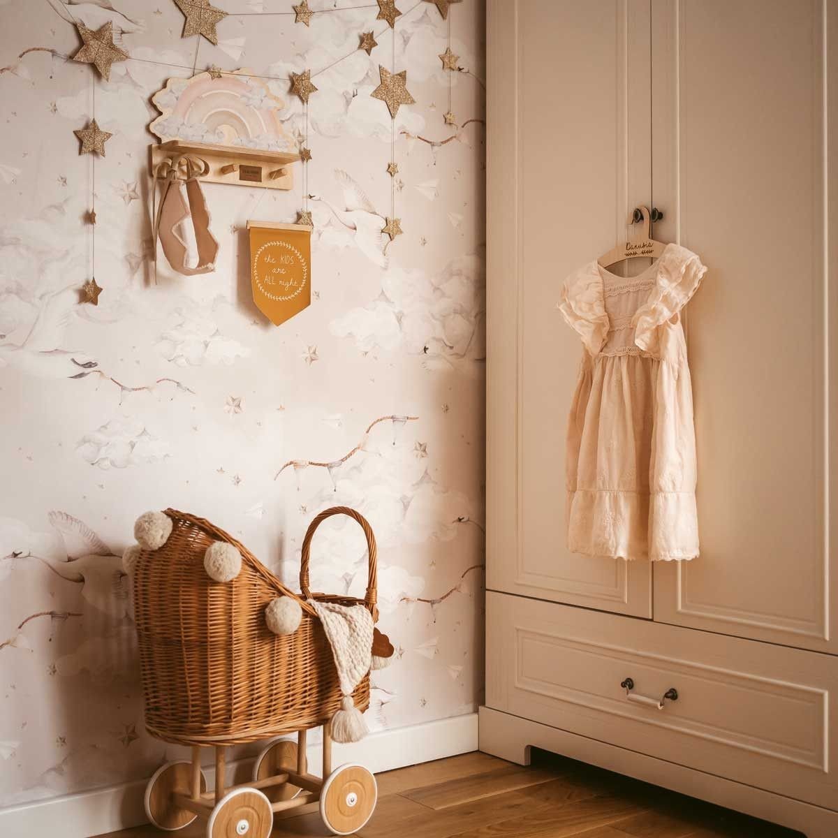 1. Dekornik pink rainbow mini wall shelf in a nursery with star decorations and wicker pram