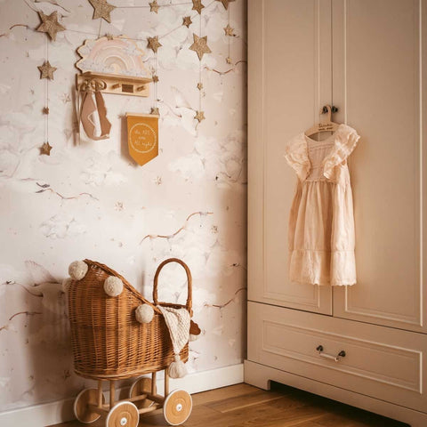 1. Dekornik pink rainbow mini wall shelf in a nursery with star decorations and wicker pram