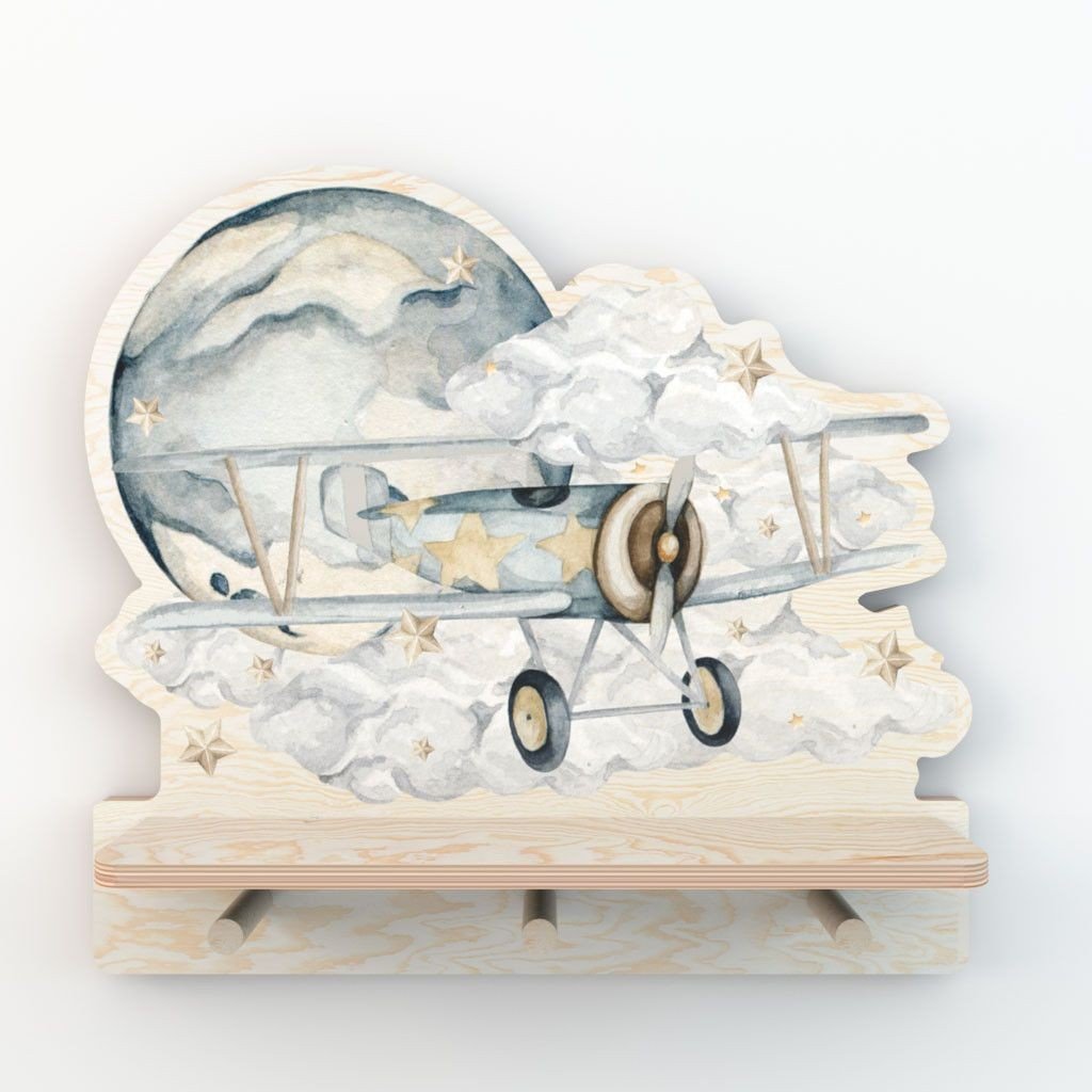2. Studio shot of Dekornik mini wall shelf with plane and cloud design, three pegs, and plywood construction