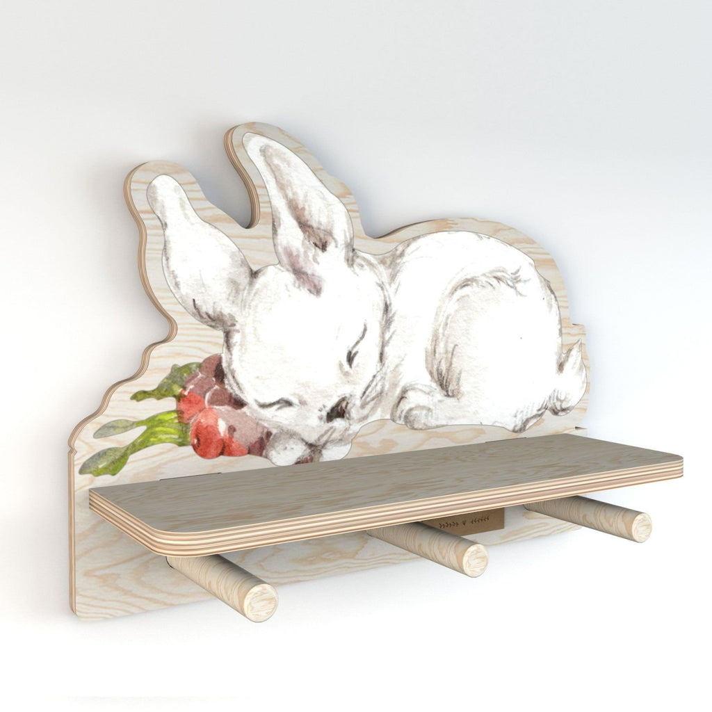 2. Side view of Dekornik mini wall shelf with rabbit design, highlighting the plywood construction and three pegs, suitable for small items, in a studio setting