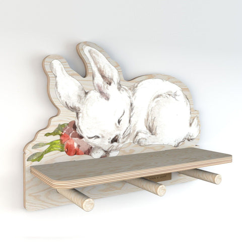 2. Side view of Dekornik mini wall shelf with rabbit design, highlighting the plywood construction and three pegs, suitable for small items, in a studio setting