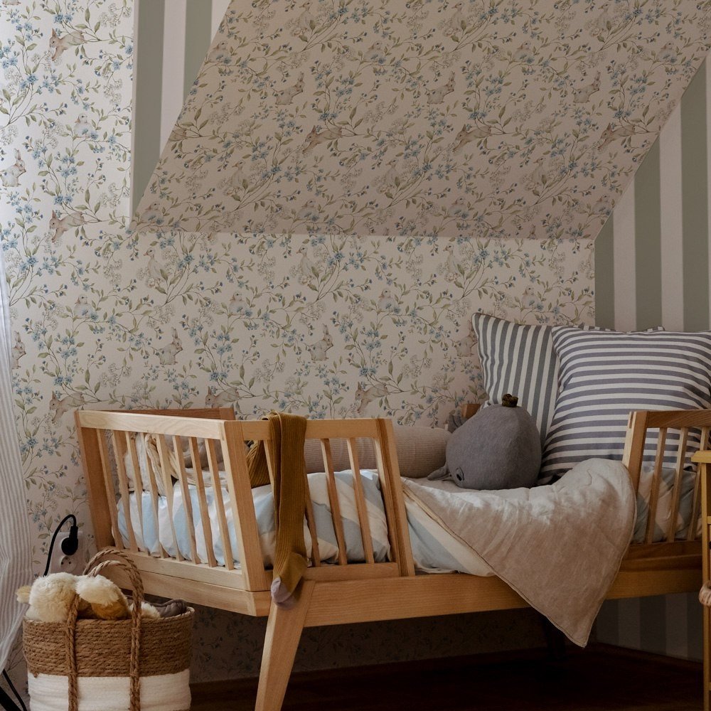 4. Cozy toddler room with wooden bed and beige wallpaper featuring ducks and bunnies