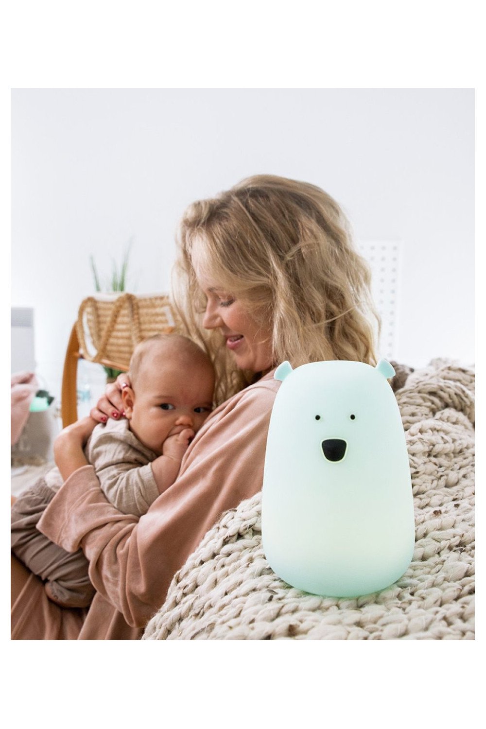 6. Mother holding baby with blue Big Bear silicone lamp by Rabbit & Friends on bed