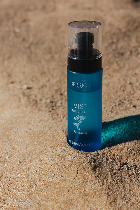 5. Berrichi MIST Face Spray bottle on sand, emphasizing natural ingredients