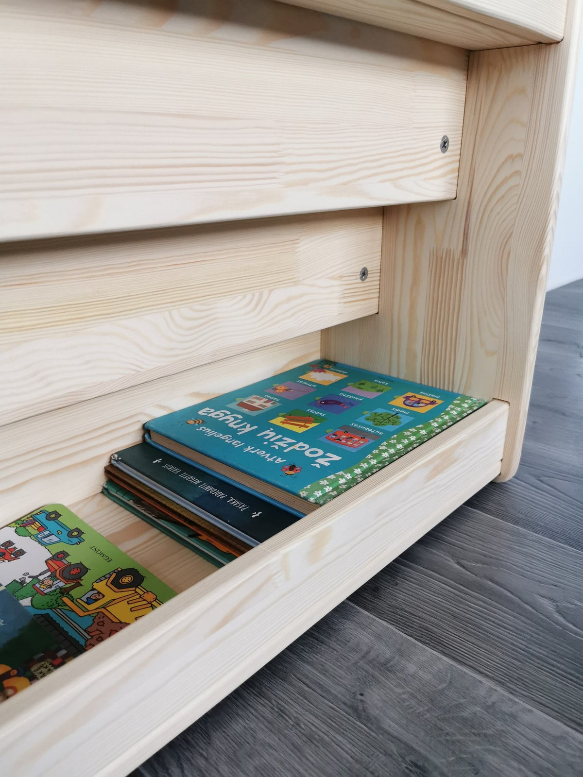 8. Close-up of lower shelf of Montessori bookshelf showing additional book storage space