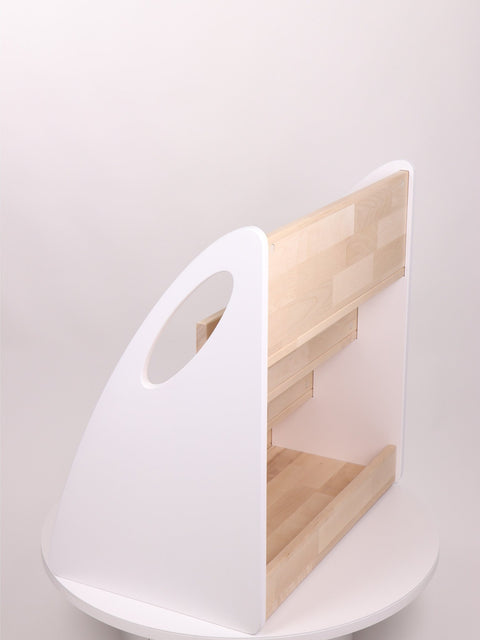 2. Side view of Montessori bookshelf with white sides and natural wood shelves on a white background
