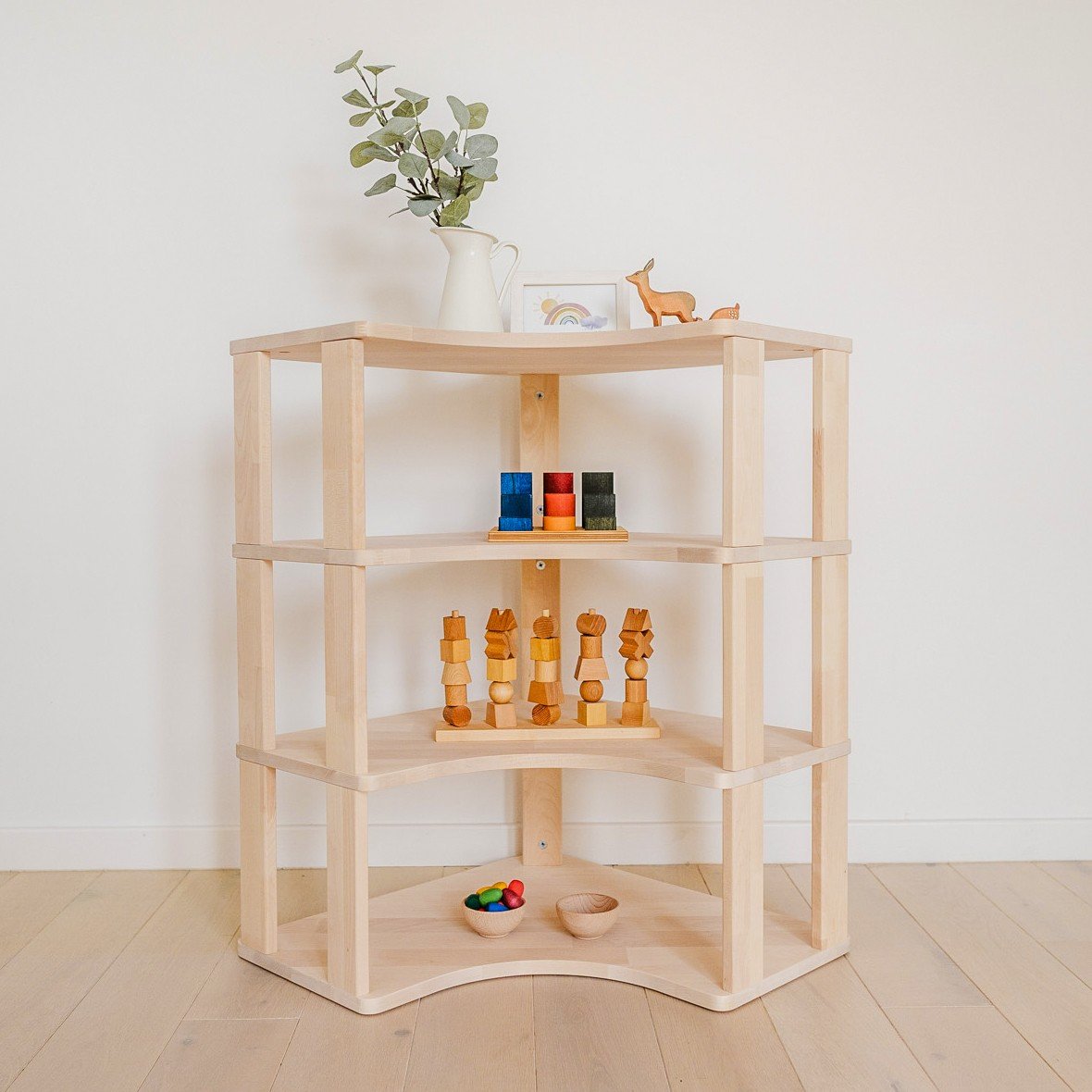 1. Solid wood Montessori corner shelf with toys and decor in a bright room