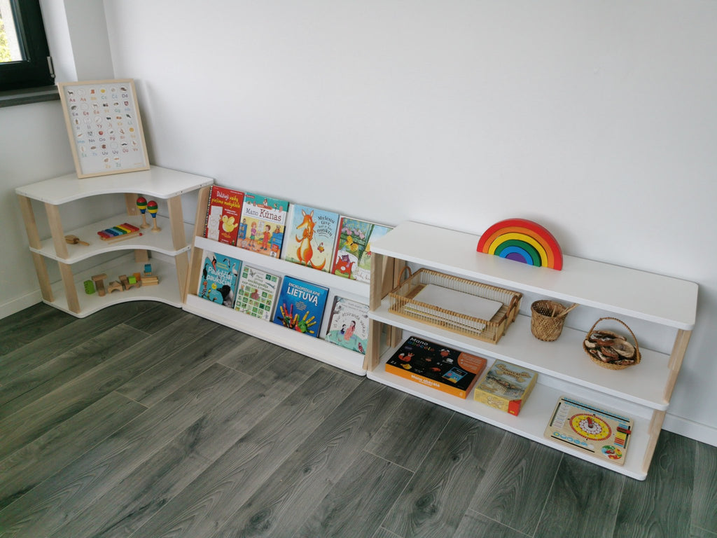 2. Modular Montessori bookshelf with two shelves displaying books and toys in a bright room