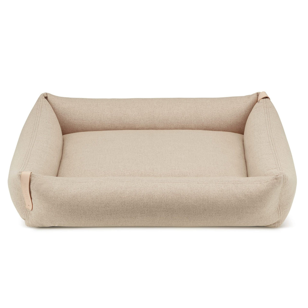 2. Sand-colored Moe dog bed by Labbvenn with a rectangular shape and raised edges, featuring a removable polyester cover and leather belt detail, shown on a white background.