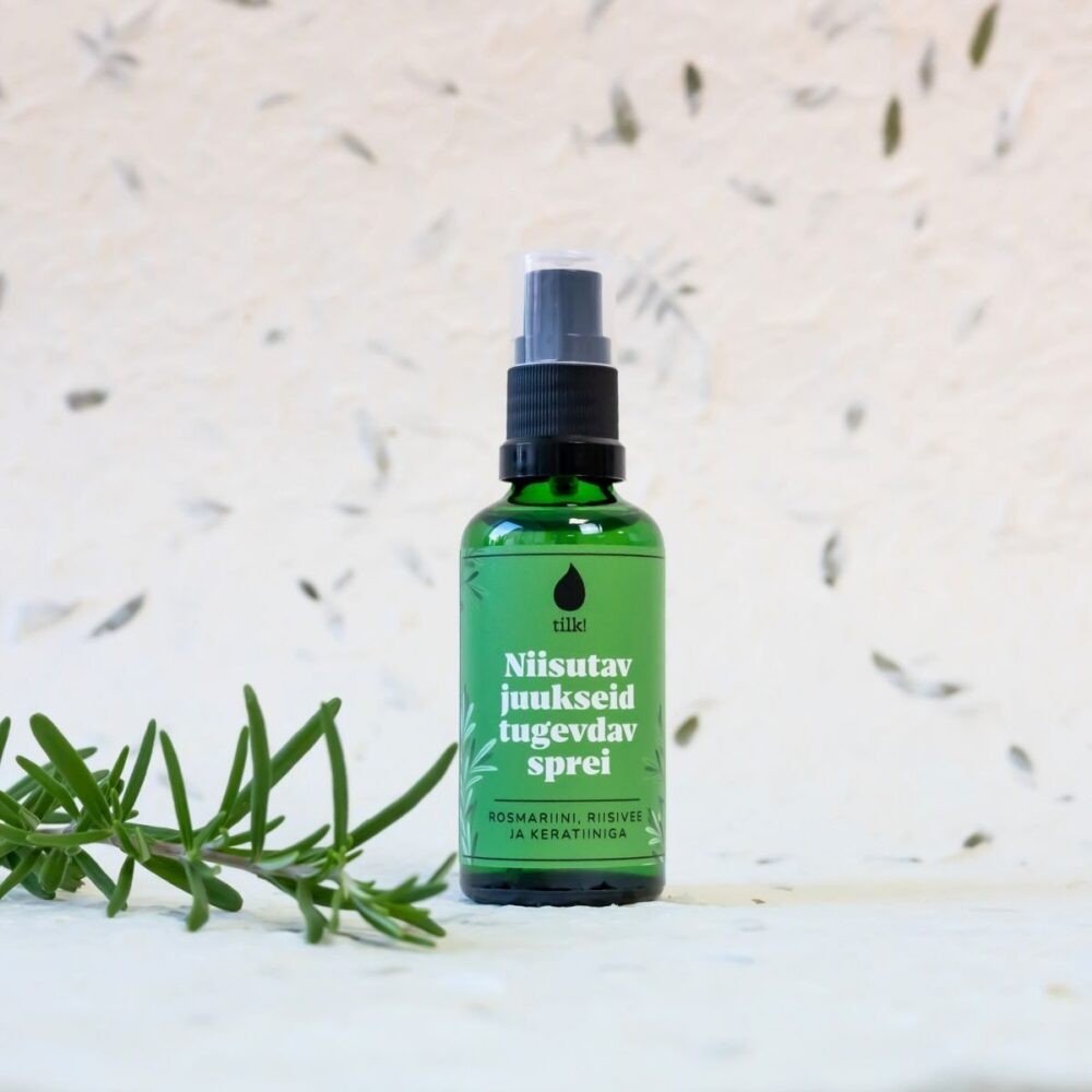 2. Tilk! Moisturizing and Strengthening Hair Spray in green bottle, studio shot