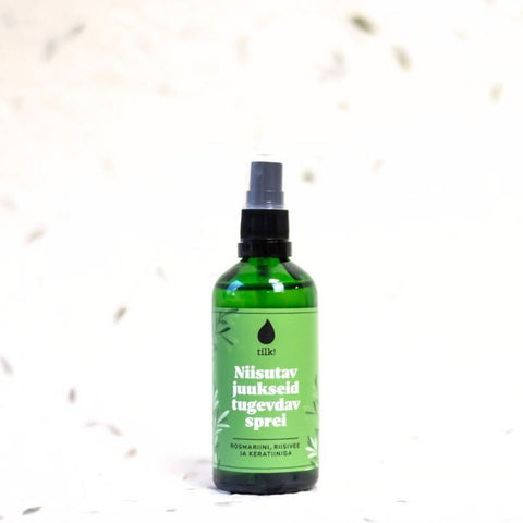 1. Tilk! Moisturizing and Strengthening Hair Spray in green bottle with rosemary, shown in lifestyle setting