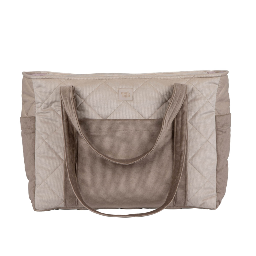 2. Front view of beige mom weekender bag with quilted pattern and long straps in studio lighting