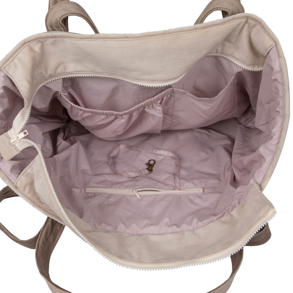 3. Interior view of beige mom weekender bag showing pink waterproof lining and multiple pockets
