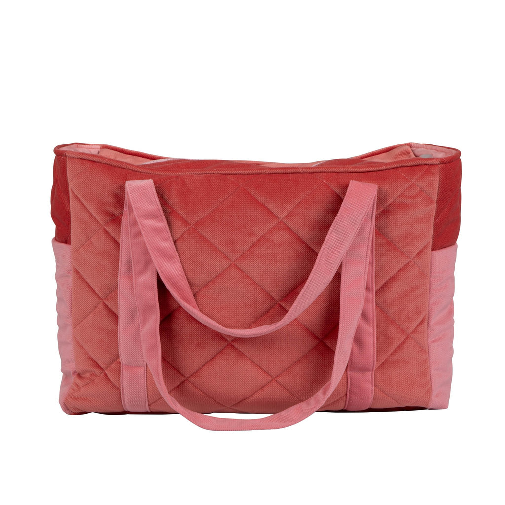 7. Back view of pink quilted weekender bag with moi mili logo and long handles in studio setting
