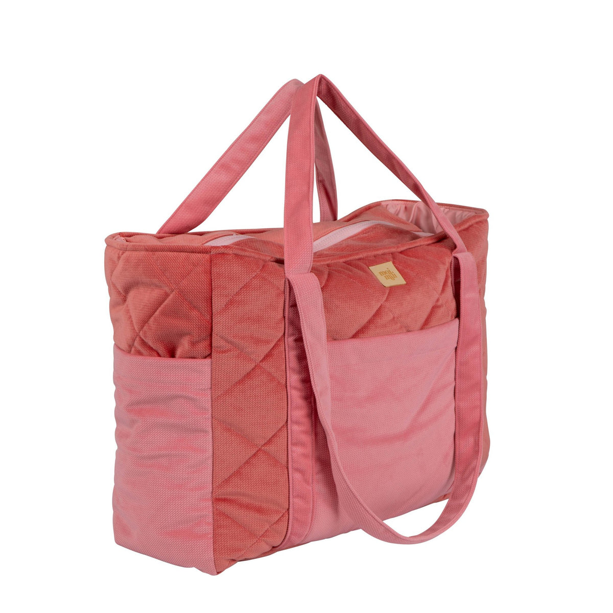3. Side view of pink quilted weekender bag showing long handles and side pockets