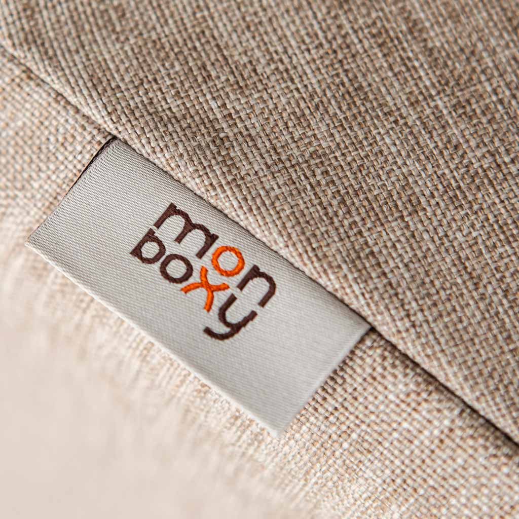 7. Close-up of Monboxy logo on beige fabric tag