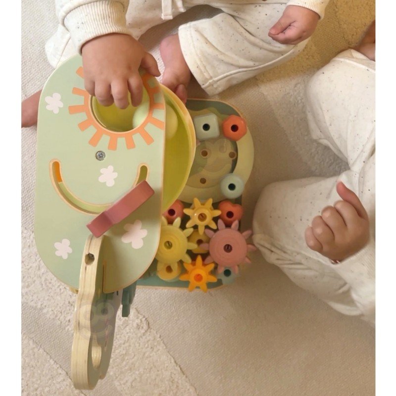 6. Top view of toddlers playing with Woopie Montessori 4-in-1 activity tree, highlighting the gear and marble run features.