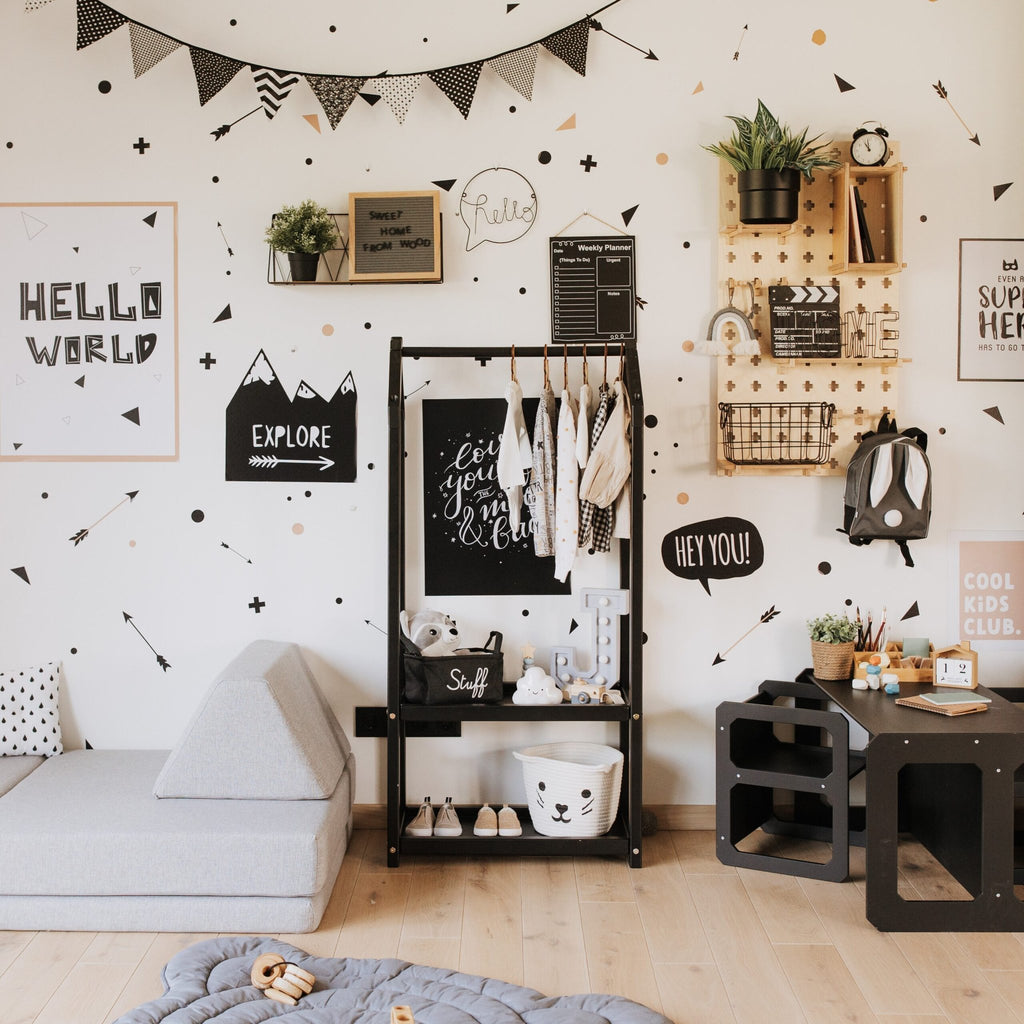 1. Black house-shaped clothing rack with children's clothes in a modern kids' room