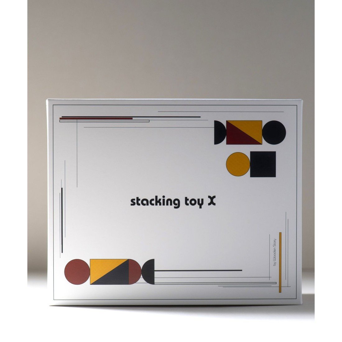 4. Packaging of stacking toy X with geometric design and text on a white box