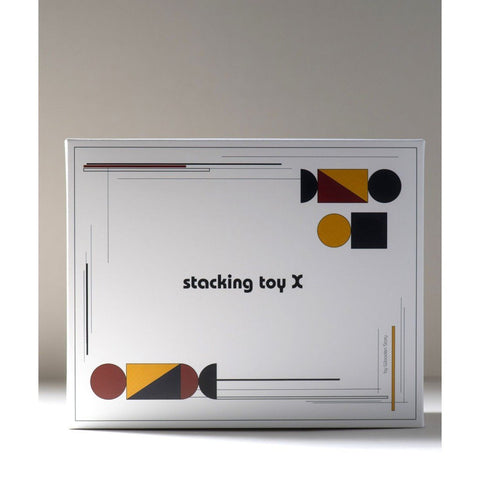 4. Packaging of stacking toy X with geometric design and text on a white box