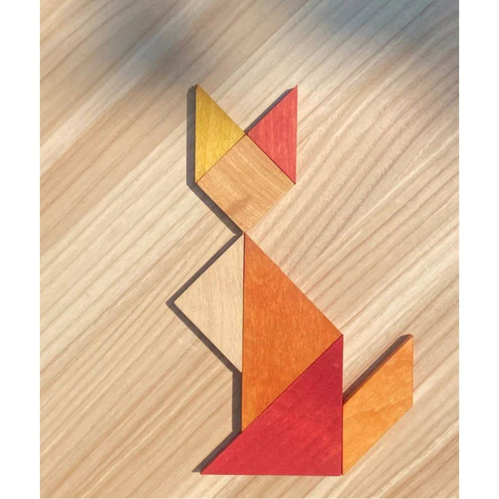 3. Wooden Story tangram pieces arranged to resemble a cat on a wooden surface